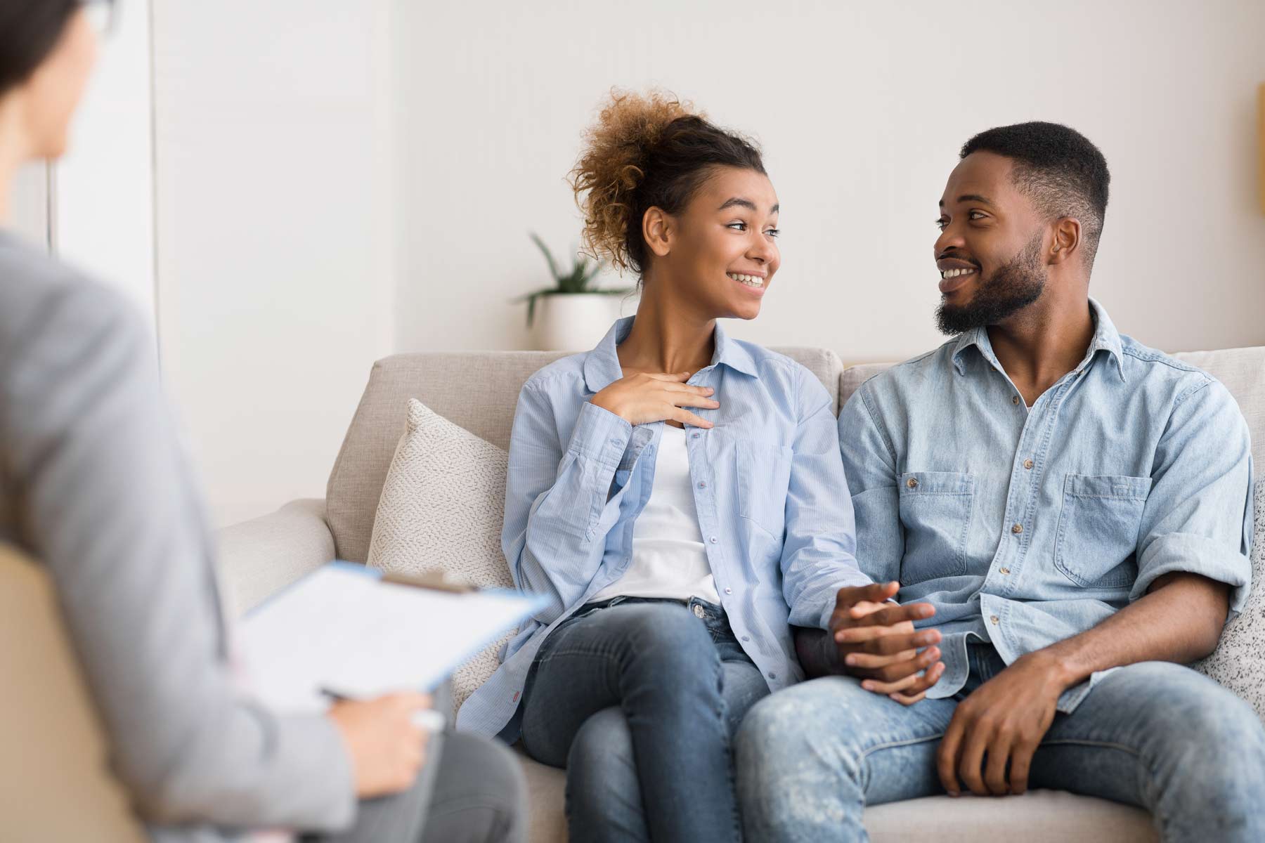 A couple sharing details about a reconciliation while in session with a therapist.